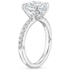 a white gold engagement ring with an oval center stone and side stones on the band