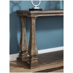 a wooden table with a metal ring on it's top and some wood pillars