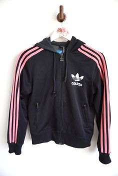 Jacket details: * Black with Pink stripes Adidas jacket * Colorful trefoil logo on back * Zipper on front and hood * Condition: Perfect vintage condition Measurements, laying flat: Length: 23" / 58 cm Armpit to armpit: 19" / 48 cm Shoulder to shoulder: 16" / 41 cm Sleeve: 23" / 58 cm Label size: 38 - M Feel free to message me with any questions Burberry Leather Jacket, Sweat Adidas, Norwegian Wool Sweater, Jacket Details, Adidas Vintage, Hoodie Jumper, Tracksuit Jacket, Adidas Trefoil, Adidas Sweatshirt