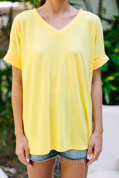 This versatile v-neck tee is here to make your life easy! It's honestly the perfect top for year round styling and layering. You can knot the hem or half tuck into your favorite jeans or shorts. You can layer it with all sorts of jackets, shackets, or kimonos. And don't even get us started on accessories! The options are absolutely endless! This top is truly a staple piece! This top features a v neckline, short cuffed sleeves, and a generous fit.Material has generous amount of stretch.Sydney is Summer Cotton V-neck Top, Versatile V-neck T-shirt For Loungewear, Yellow V-neck Top For Loungewear, Spring Cotton V-neck Top For Loungewear, Cotton V-neck Top For Spring Loungewear, Summer Short Sleeve V-neck Top For Loungewear, Spring Everyday V-neck Top, Summer V-neck Top With Short Sleeves For Loungewear, Cotton V-neck Top For Summer