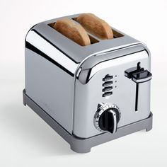 two slices of bread are sitting on top of a silver toaster that is open