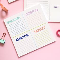 two notebooks with the words grocery, target and amazon written on them next to some office supplies