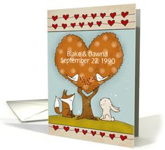 a card with an image of two dogs and a tree in the shape of a heart