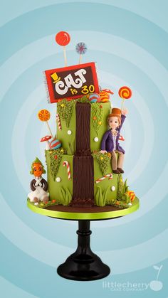 a three tiered cake decorated with cartoon characters