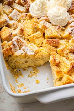 a close up of a pie in a pan with some whipped cream on the top