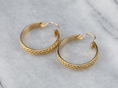 Absolutely gorgeous, these woven yellow gold hoop earrings catch the light in an excellent way! These are substantial in look but lightweight and easy to wear. The locking back closes securely, and the detailed braid design gives them marvelous dimension and texture. Metal: 14K Yellow Gold Earrings Length: 31 mm Earrings Width: 27 mm Marks: “14K” Stamped Yellow Gold Jewelry With Interwoven Design, Texture Metal, Braid Designs, Yellow Gold Earrings, Yellow Gold Jewelry, Yellow Gold Earring, Gold Hoops, Gold Hoop, Gold Hoop Earrings