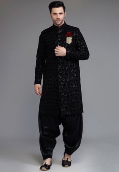 Ready-made Velvet Straight Embroidered Sherwani in Black Color. Crafted in Chinese Collar and Full Sleeves, This Ready-made attire with Satin Lining is Enhanced with Buttons, Pockets, Sequins and Resham Work. Available with a Satin Dhoti Pant in Black Color.   Do note: Footwear, Stole and Brooch shown in the image is for presentation purposes only. Half to one inch may vary in measurement. (Slight variation in actual color vs. image is possible) We sell all kinds of Menswear. Mens Sherwani | Men Black Churidar With Traditional Drape And Self Design, Black Bandhgala With Chikankari Embroidery Bollywood Style, Navratri Party Sherwani Straight Kurta, Black Bollywood Kurta With Pallu, Party Embroidered Sherwani Straight Kurta, Black Sherwani With Zari Work For Navratri, Ceremonial Anarkali Churidar For Transitional Season, Traditional Black Bandhgala With Chikankari Embroidery, Bollywood Style Festive Sherwani With Embroidery