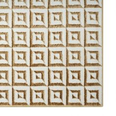 a brown and white area rug with squares on the top, in front of a white background