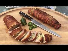 sliced meat on a cutting board with knife and jalapenos