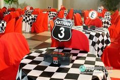 the tables are decorated with black and white checkered tablecloths, red chairs, and hats