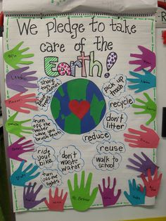 a bulletin board with handprints on it that says we pledge to take care of the earth