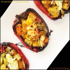 three stuffed peppers on a white plate topped with cheese and other food items in them