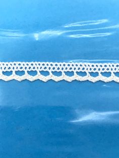 a white crochet lace on a blue background