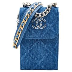 This crossbody bag is made of blue denim with blue leather details and features a sliver chain crossbody strap interlaced with blue leather, a leather shoulder pad, a front flap with snap closure, sliver tone and gold hardware and a blue fabric interior with card slots. Chanel bags with the serial number 31XXXXXX are manufactured from 2021. COLOR: Blue MATERIAL: Cotton - Denim ITEM CODE: 31926315 MEASURES: H 7” x L 4” x D 2” DROP: 26” EST. RETAIL: COMES WITH: Dust bag, care cards, authentication Chanel Phone Holder, Chanel Denim, Denim Crossbody Bag, Quilted Denim, Chanel Blue, Blue Jeans Crafts, Chanel 19, Denim Crossbody, Planner Covers