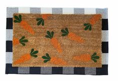 a door mat with carrots on it and checkered table cloth behind the rug