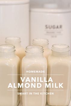 some jars are lined up next to each other with the words, homemade vanilla almond milk smart in the kitchen