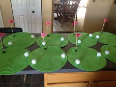 several green plates with golf balls on them