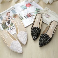 three pairs of women's shoes sitting on top of a wooden floor next to an open magazine