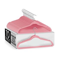 a pink hanger in a white box with the top open to show it's clothes