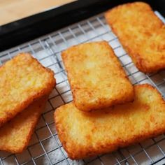 some fried food is sitting on a cooling rack and ready to be cooked in the oven