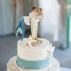 a wedding cake with a bride and groom figurine on top