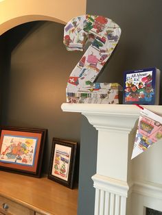 the number two is made out of children's books on top of a mantle