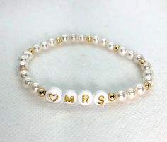 "This listing is for ONE custom heishi bead bracelet.  (See bridal stack listing if you're wanting all three: https://etsy.me/3b200dN) Use drop down to select pearl or colors. You'll use the personalization box to let me know if you're choosing the Mrs. or the Bride. NOTE If you're ordering more than 1 you'll need to add each bracelet to the cart separately with notes for that particular bracelet. (Message me if you're wanting some \"bride tribe\" bracelets to go with it.) These are stretch brac White Stackable Beaded Bracelets For Wedding, White Stackable Beaded Wedding Bracelets, Adjustable 8mm Beads Bracelets For Wedding, Personalized White 8mm Beaded Jewelry, Personalized White Jewelry With 8mm Beads, Adjustable White Bracelet For Anniversary, White 8mm Beads Bracelets For Wedding, Stackable Round Beaded Bracelets For Weddings, White 8mm Bead Jewelry For Personalized Gifts