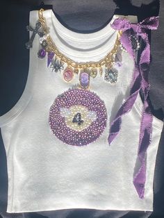 Women's fashionable pool ball tank top, with chunky charm necklace and bow.  Perfect for any occasion or style. | coquette| pool ball | Trending tank top | Jewelry | Chunky charms | Charm necklace | Pool ball design | Beaded shirt | Beaded apparel | Purple top | Trending Fashion | Gold and Silver Jewelry Jewelry Design Aesthetic, Bejeweled Clothes, Tank Top Design Ideas, Novelty Fashion, Bead Top Diy, Sleeveless Graphic Tee, Beaded Tank Top Diy, Beads Shirt, Beading Clothes