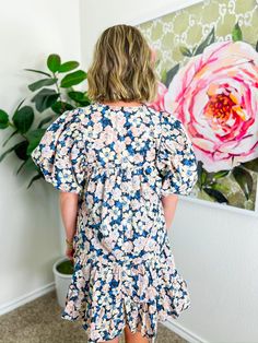 Adorned with a delightful floral print in soft blue, light pink, and cream, this mini dress features smocked shoulders and puff sleeves that add a touch of whimsy. With its flowy fit and ruffle hem, it’s ideal for a breezy fall day at a pumpkin patch, a casual brunch with friends, or even a fun date night! PRODUCT FIT - TRUE TO SIZE MODEL DETAILS - BRENNA IS WEARING A SIZE SMALL, 5'3" BUST CIRCUMFERENCE -SMALL 36", MEDIUM 38”, LARGE 40” LENGTH -SMALL 33.5", MEDIUM 34.5”, LARGE 35.5” FABRIC CONTE Ditsy Floral Print Flutter Sleeve Dress For Brunch, Floral Short Sleeve Dress With Smocked Back For Brunch, Short Sleeve Smock Floral Dress For Garden Party, Cute Dresses With Gathered Sleeves For Brunch, Blue Floral Print Puff Sleeve Mini Dress, Summer Floral Print Tiered Puff Sleeve Dress, Flowy Puff Sleeve Dress With Floral Print For Brunch, Tiered Puff Sleeve Dress With Floral Print For Brunch, Flowy Floral Puff Sleeve Dress For Brunch