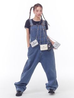 This product offers a relaxed and stylish take on the classic denim overalls, with a wide-leg design that combines retro vibes with modern comfort. The adjustable straps and spacious front pocket add both functionality and a playful touch to the piece. It's a versatile garment that can be styled up or down, perfect for a variety of casual occasions. - The overalls feature a wide-leg cut that ensures freedom of movement and a trendy silhouette.- Adjustable shoulder straps provide a customizable fit for various body types.- A large front pocket adds practicality, perfect for carrying small essentials.- Constructed with durable denim, these overalls are designed to withstand regular wear and maintain their shape. Trendy Wide-leg Overalls For Workwear, Trendy Everyday Denim Jumpsuit With Pockets, Trendy Denim Overall Jumpsuit For Everyday, Trendy Denim Jumpsuit With Adjustable Straps, Trendy Denim Overall Jumpsuit, Casual Jeans With Adjustable Straps, Trendy Wide Leg Denim Jumpsuit With Pockets, Trendy Denim Jumpsuit With Side Pockets, Chic Overall Jeans With Pockets