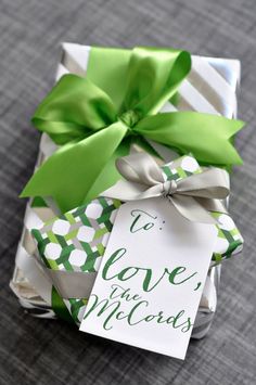 a gift wrapped in green and white paper with a tag that says to leave the cards