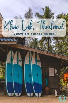 three surfboards are lined up in front of a building with the words khao lak thailand on it