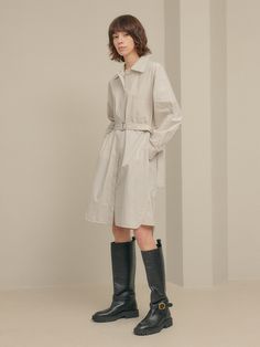 Editor's notesIt is a shirt dress inspired by trench coat design. The dress features a belt, hidden button, top-stitching point, pockets on the front, and side slits. It is a refreshing dress made of cotton fabric.- Relaxed fit- Trench coat design- Top-stitching point- Side slits- 100% CottonMeasurements(in.)One Size- Shoulder: 21.3 in.- Chest: 22.8 in.- Hem: 24.6 in.- Sleeve Length: 20.3 in.- Sleeve: 9.1 in.- Front Length: 39.4 in.- Back Length: 40.9 in.*Model info- Height 5’ 9” Bust 34” Waist Spring Beige Shirt Dress With Placket, Chic Workwear Shirt Dress With Roll-up Sleeves, Chic Spring Shirt Dress With Roll-up Sleeves, Chic Shirt Dress With Roll-up Sleeves For Work, Classic Spring Shirt Dress With Hidden Button Closure, Spring Business Casual Shirt Dress With Spread Collar, Spring Shirt Dress With Belted Cuffs And Spread Collar, Beige Collared Belted Shirt Dress, Spring Shirt Dress With Belted Cuffs