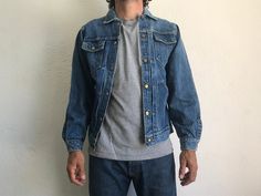 "Vintage Denim Pleated Jacket Buckaroo by Big Smith Made in USA 1950s Denim jacket in washed blue indigo . Nice patina. Sanforized Typical pleats on frond 6 snap-buttons front . Buttoned cuffs. All buttons are signed Big Smith. Double chest-pockets and lower pockets. Horseshoes stitching on the chest pockets. Label inside and on left low pocket. Vintage item in good condition. 100% Cotton Estimated size: M. Size on tag: 38. Our women model in the photos wears usually size S and measures 170cm/ 6 Vintage Washed Denim Jacket, Fitted Vintage Outerwear In Medium Wash, Vintage Faded Denim Jacket For Spring, Vintage Fitted Light Wash Denim Jacket, Vintage Fitted Medium Wash Outerwear, Vintage Fitted Light Wash Outerwear, Vintage Light Wash Denim Jacket, Vintage Light Wash Denim Jacket With Pockets, Vintage Light Wash Outerwear With Pockets