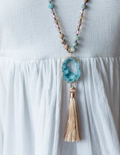 DETAILS Handmade Beaded with cotton tassel Matching bracelets available Designed in Delray Beach, FL DIMENSIONS Neck drop: 20 in *all measurements are approximate Adjustable Spiritual Tassel Necklace For Festivals, Spiritual Beaded Tassel Necklace For Beach, Spiritual Beach Necklaces With Tassels, Adjustable Spiritual Tassel Necklace With Natural Stones, Beaded Tassel Necklace With Round Beads For Beach, Blue Tassel Necklace For Beach, Adjustable Tassel Necklace With Natural Stones For Gift, Adjustable Bohemian Tassel Necklace, Turquoise Tassel Necklace For Beach