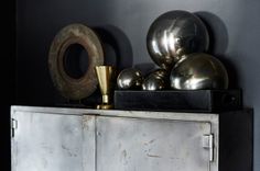 an old metal cabinet with some metallic balls on top