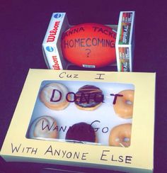 a box that has some doughnuts in it and an orange ball behind it