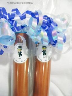 two orange juice bottles with blue bows and ribbons on them, sitting next to each other