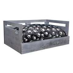 the bed frame is made out of wood and has black and white spots on it