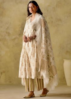 Featuring an ivory leaf block printed cotton kurta, complete with lace embellishments on the neck and sleeves as well as pleats on the sides. The set comes with a striped palazzo and dupatta with a wide lace cutwork border. Composition : Kurta: Mul Cotton Lined With Mul Cotton, Palazzo: Cambric Cotton, Dupatta: Mul Cotton Care: Dry Clean Only and Vacuum Storage All products can be customised for sleeves, length of blouse and neck design Delivery : 3-4 weeks as the product is hand crafted. Check Size Guide or choose MySize for free customisation (All Sizes above XL can be made at 15% additional cost) For more information and sizes please contact fabiliciousfashion@gmail.com or visit our Copenhagen studio. Kurta And Dupatta, Cotton Anarkali, Palazzo Set, Indian Wedding Wear, Cut Work, Wedding Wear, Anarkali, Aza Fashion, Neck Designs