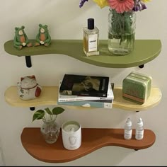 two shelves with vases and books on them