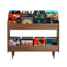 a wooden book shelf filled with lots of books on top of each other in front of a white background