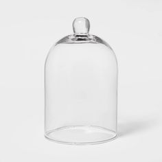 an empty glass bottle with a lid on a white background, there is no image here to provide a caption for