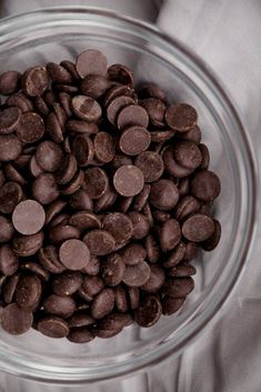 a glass bowl filled with chocolate chips