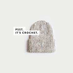 a white knitted hat with the words pst it's crochet