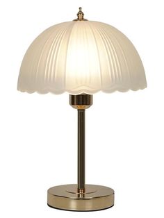 a lamp that is sitting on top of a metal stand with a white shade over it