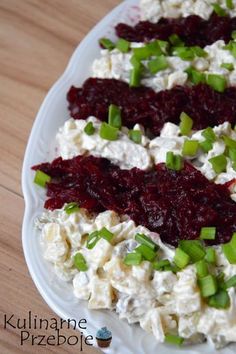 a white plate topped with cranberry salad on top of a wooden table next to a fork