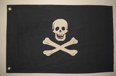 a pirate flag with a skull and crossbones on the front, hanging from a wall