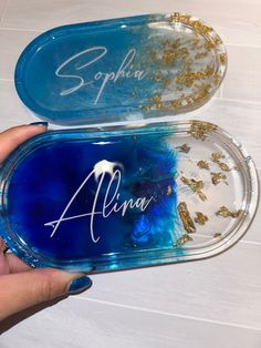 two personalized glass trays with gold flakes on the bottom and blue inside