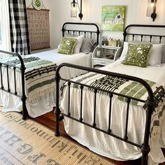 two beds in a bedroom with green and white decor